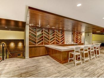 Clubroom with built-in bar at The Whittaker, Seattle, WA,98116 has Clubroom with built-in bar and wine storage